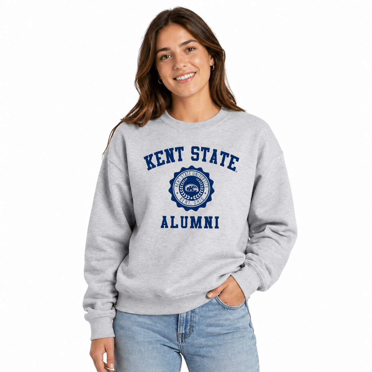 Woman wearing a gray Kent State Alumni With Crest Sweatshirt featuring a navy blue Kent State University crest, styled with light blue jeans against a white background.